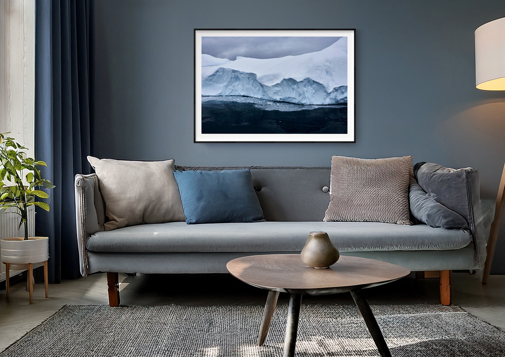 Colour photograph of a glacier edge with fractured ice, displayed in a styled interior setting (mockup)