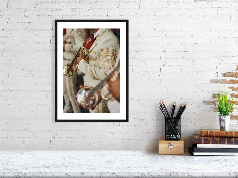 Colour photograph of a mariachi musician displayed as a framed print in a styled interior desktop setting (mockup)
