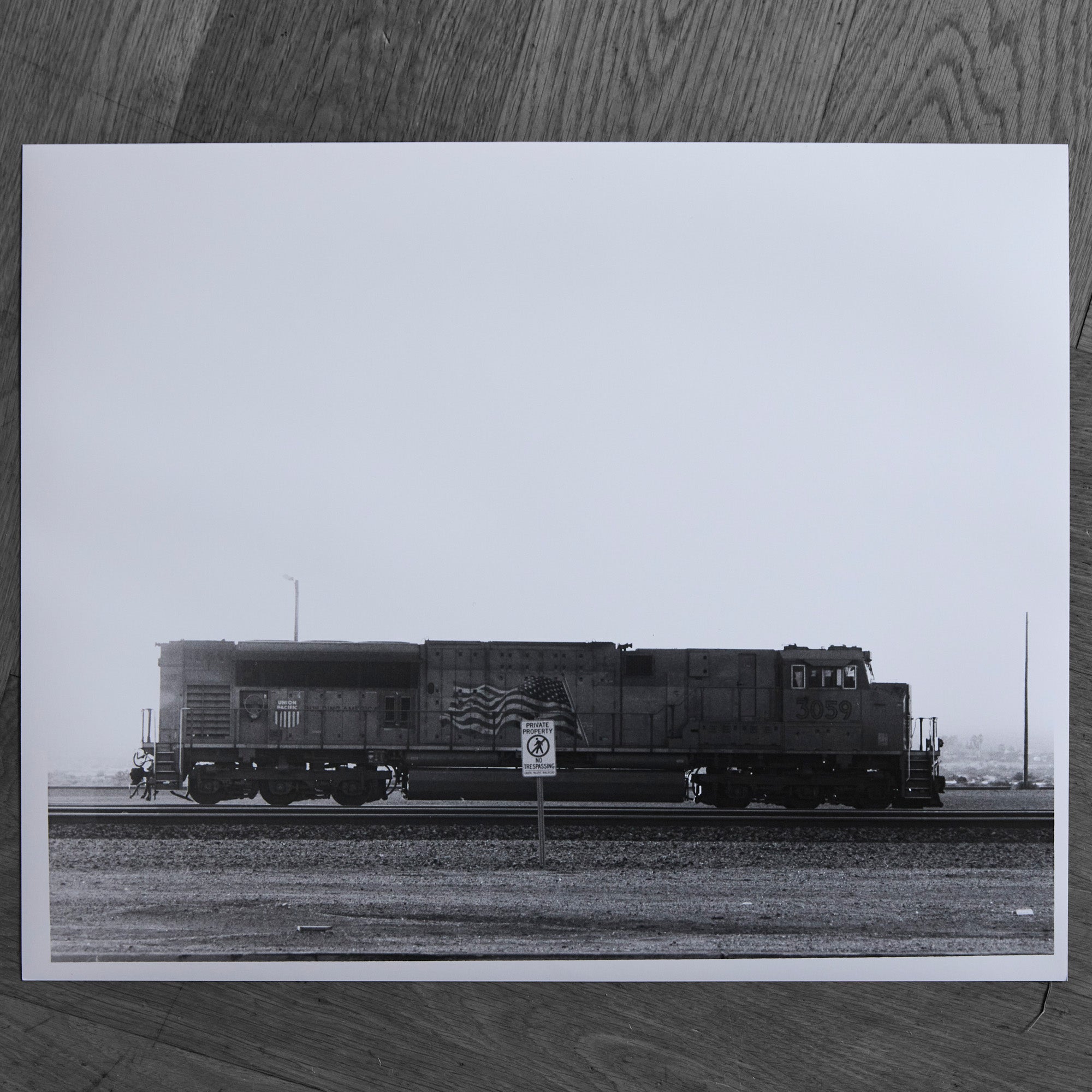 One-off black and white darkroom photograph of a freight train in a rural landscape, hand-printed by the artist.