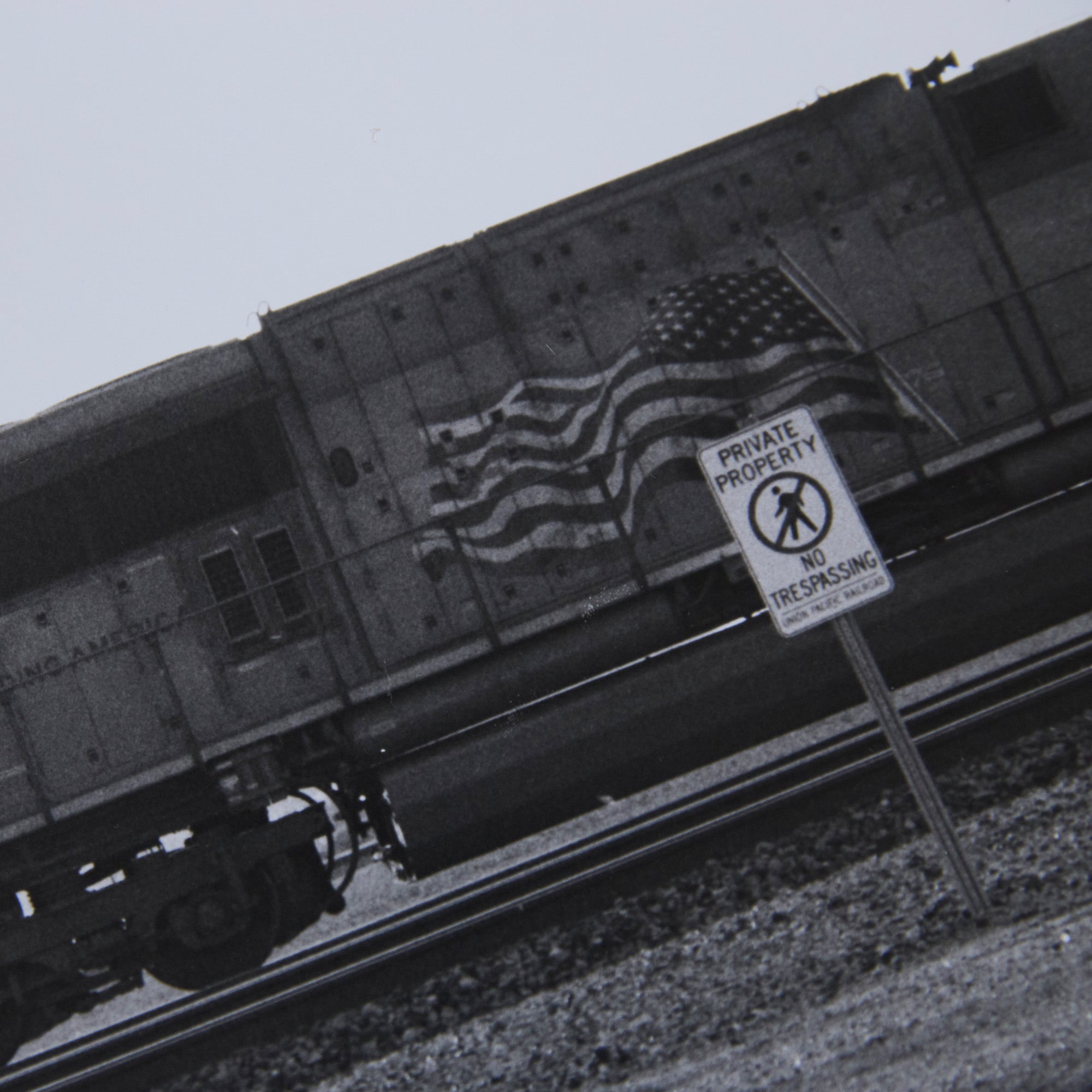 Detail of a one-off black and white darkroom photograph of a freight train in a rural landscape, hand-printed by the artist.