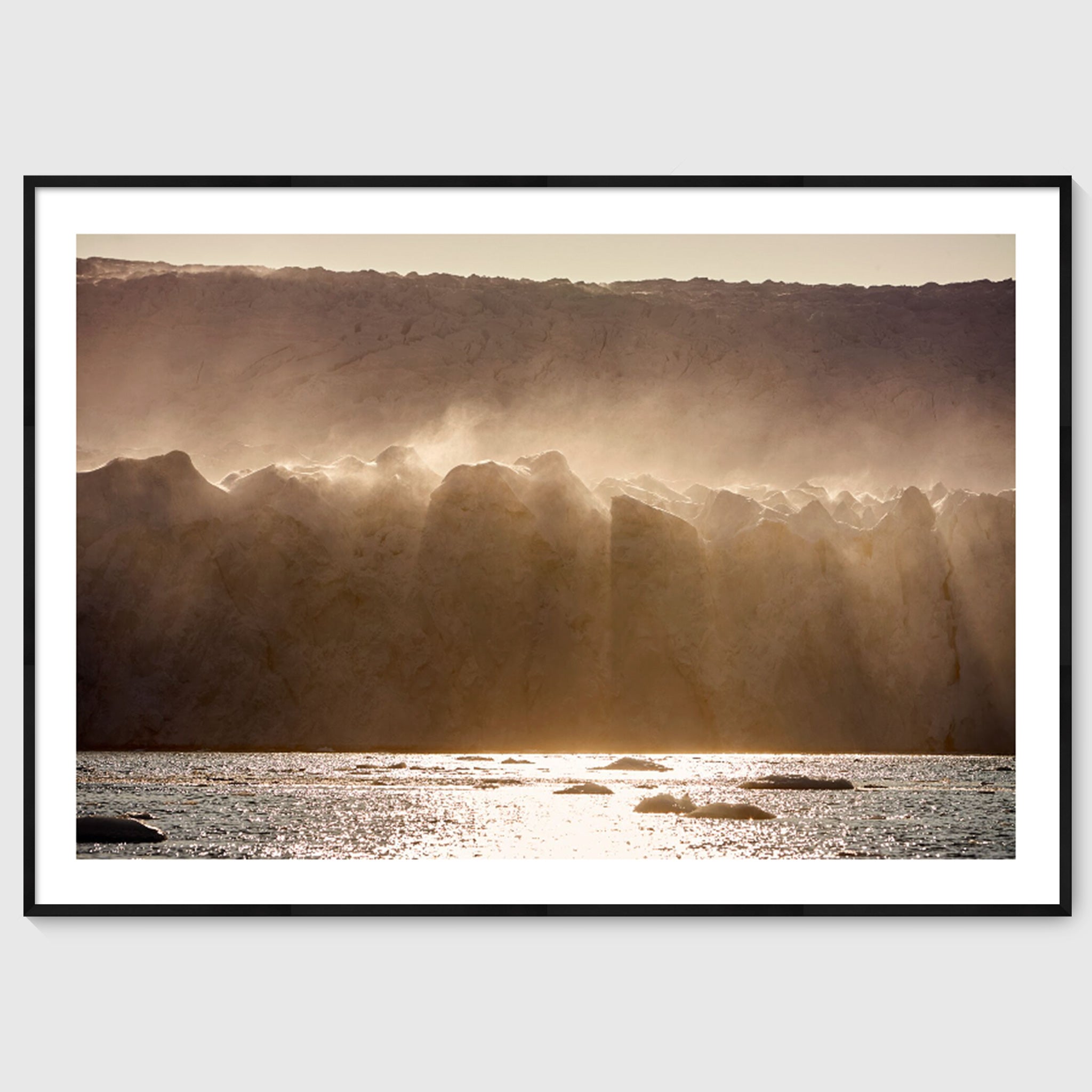 Colour photograph of wind-blown ice formations along a glacier wall, shown in a black frame, Greenland