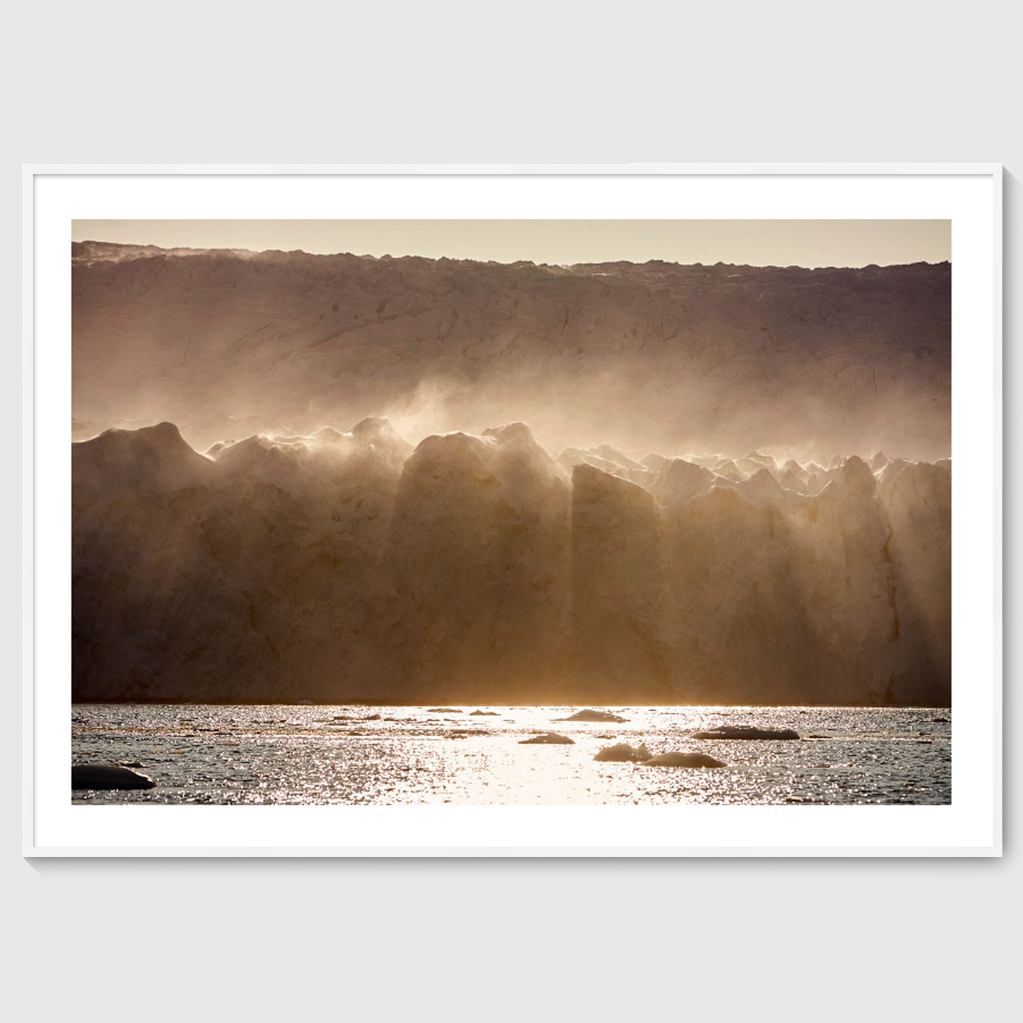 Colour photograph of wind-blown ice formations along a glacier wall, shown in a white frame, Greenland