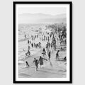 Black and white photograph of a beach scene displayed in a styled interior desktop setting (mockup)
