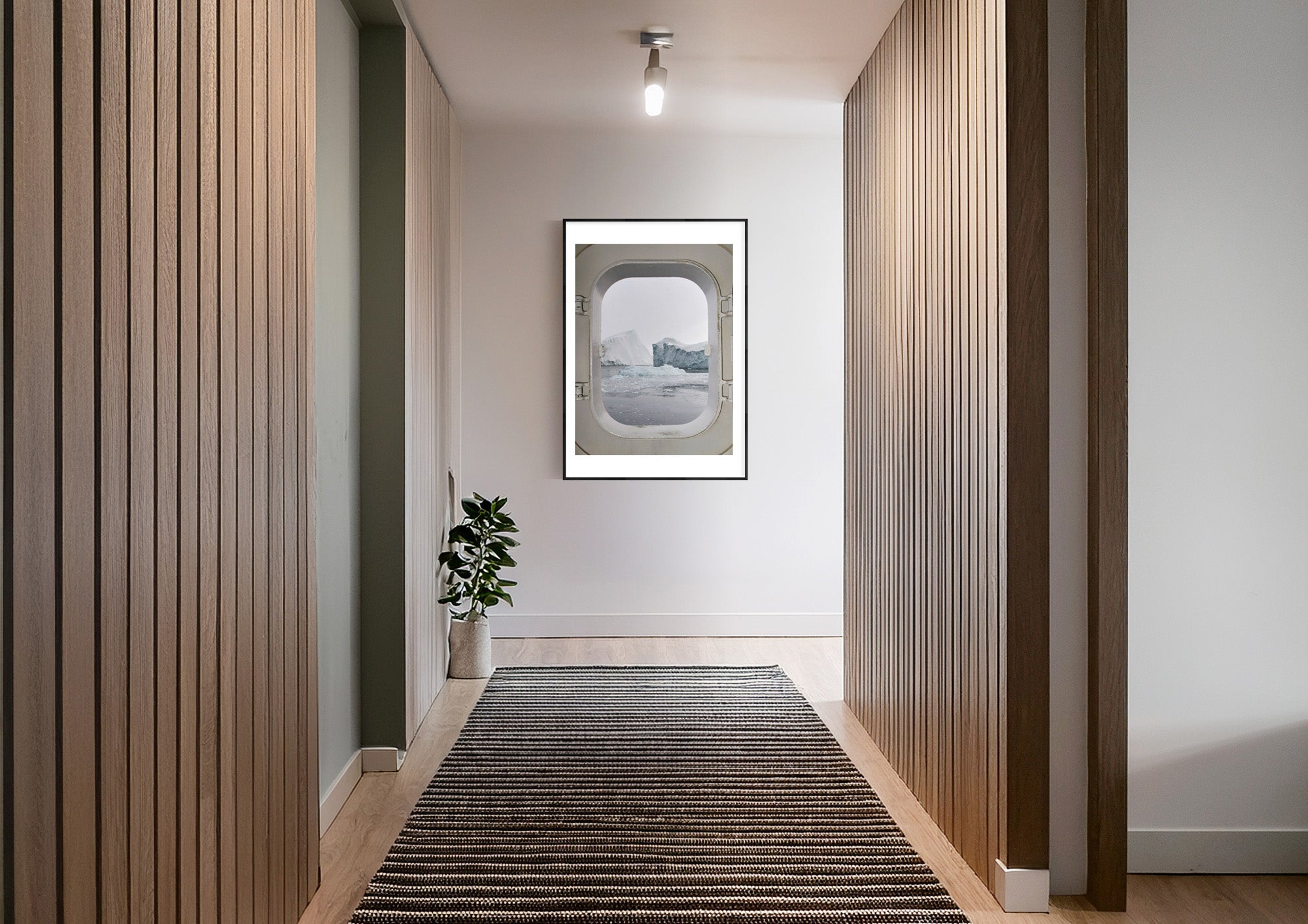 Colour photograph of an iceberg seen through a doorway, displayed in a styled interior setting (mockup)