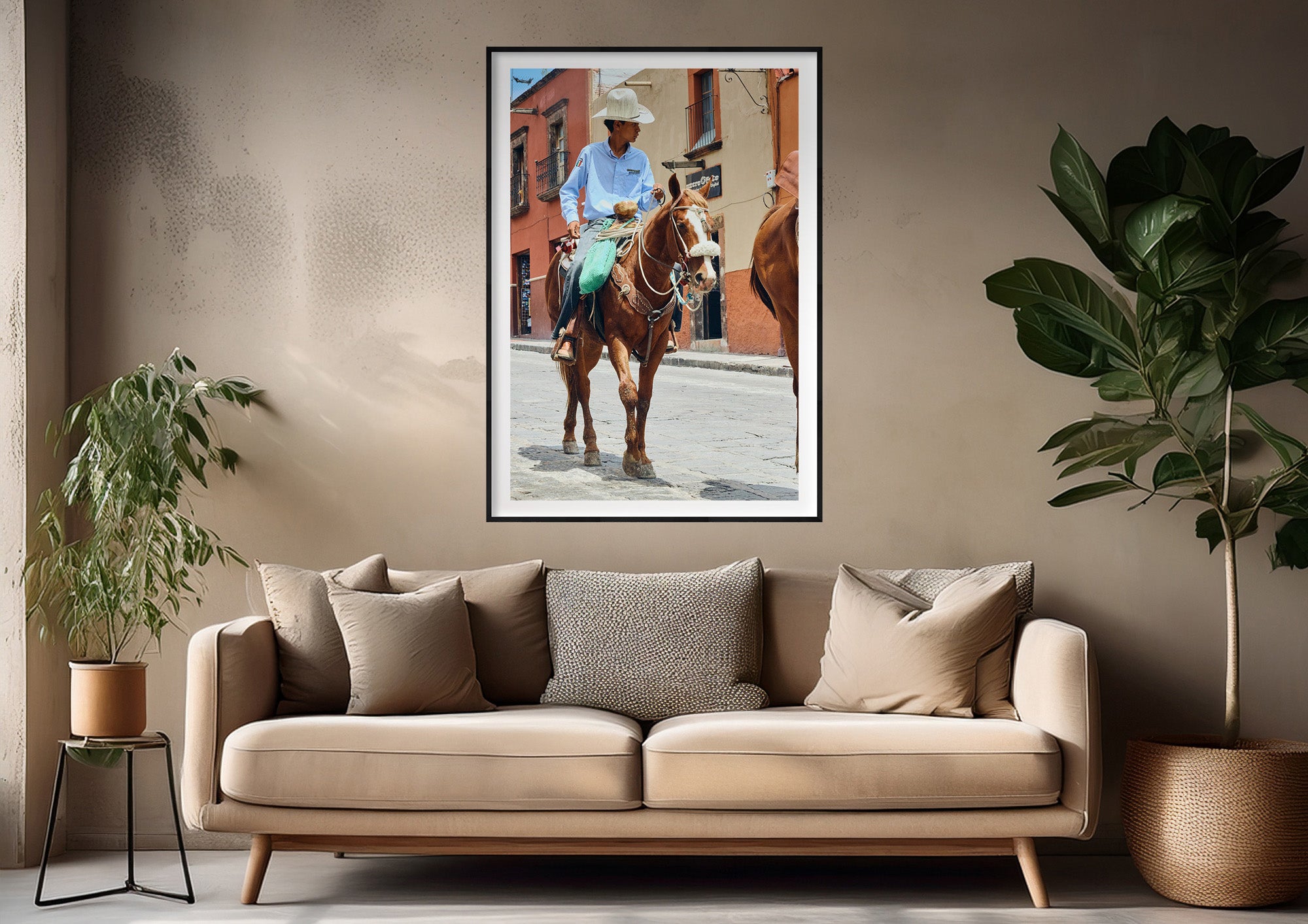Colour photograph of a vaquero on horseback displayed as a framed print in a styled interior setting (mockup)